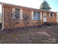 Charming brick home featuring white shutters, a manicured lawn, and a welcoming front entrance at 2333 Howells Ferry Rd, Hickory Grove, SC 29717