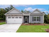 Charming single-story home with stone accents, a two-car garage, and a well-manicured front lawn at 4037 Bolo Dr, Charlotte, NC 28215