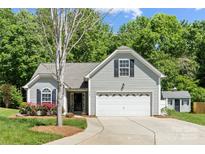 Charming home with a two-car garage, complemented by lush landscaping and a cozy shed at 4323 Wiregrass Rd, Indian Land, SC 29707