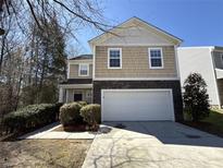 Charming home with a two-car garage, stone accents, and manicured landscaping at 5011 Abercromby St, Charlotte, NC 28213