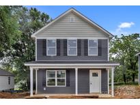 Charming two-story home with gray siding, black shutters, and a welcoming front porch at 515 Harrel St, Salisbury, NC 28144