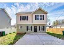 Inviting two-story home featuring a large driveway and a well-maintained lawn at 5524 Howard St, Charlotte, NC 28269