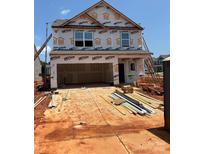 New construction home with a two-car garage and visible framing at 5704 Skinny Dr, Charlotte, NC 28215