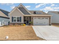 Charming single-Gathering home featuring stone accents and a two-car garage at 6419 Cambridge Dr, Harrisburg, NC 28075