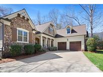 Charming home featuring stone accents, a two-car garage, and a well-manicured lawn at 147 Pearl Bay Dr, New London, NC 28127