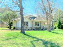 Charming single story home with stone facade and covered porch, surrounded by a spacious front yard at 2033 Shelby Rd, Kings Mountain, NC 28086