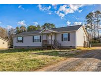 Charming single-story home with light gray siding, dark shutters, and a welcoming front porch at 340 W Memorial Hwy, Harmony, NC 28634