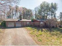 Charming single-story brick home with attached two-car garage and a long driveway at 3442 Lester St, Conover, NC 28613