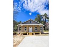 Charming single-story home with inviting front porch and modern neutral color exterior at 406 White Store Rd, Wadesboro, NC 28170