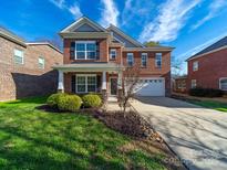 Beautiful two-story brick home with a well-manicured lawn and a welcoming front porch at 4127 Stacy Blvd, Charlotte, NC 28209