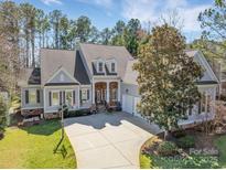 Charming traditional-style home with an inviting entryway, three-car garage and a well-manicured front yard at 4536 Rustling Woods Dr, Denver, NC 28037