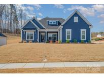 Charming blue two-story home with a well-manicured lawn and inviting curb appeal at 456 Lucky Dr, Concord, NC 28027