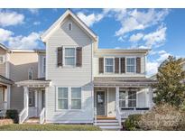 Charming two-story home with a welcoming front porch and beautiful landscaping on a sunny day at 758 Waterscape Ct, Rock Hill, SC 29730