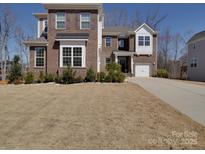 Charming brick home with an attached two-car garage and well-maintained front yard at 9786 Verdun Ct, Fort Mill, SC 29707