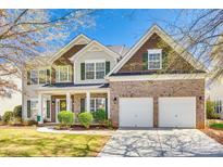 Charming two-story home featuring a brick front, two-car garage, and well-maintained landscaping at 10123 Barrands Ln, Charlotte, NC 28278