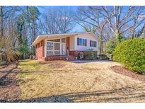 Charming home with a brick and siding facade and a well-maintained lawn, perfect for curb appeal at 2300 Highlawn Dr, Charlotte, NC 28212