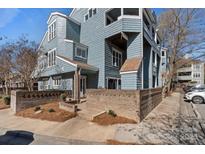 Charming blue condo exterior featuring brick accents, offering a unique and inviting curb appeal at 419 W 8Th St, Charlotte, NC 28202