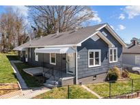 Charming single-story home featuring a landscaped yard and a welcoming front porch at 512 Washington St, Cramerton, NC 28032