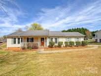 Charming single story home featuring a cozy front porch and well-manicured landscaping at 82 22Nd Nw Ave, Hickory, NC 28601