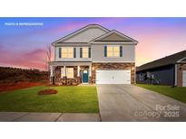 Two-story home with stone accents, a two-car garage, lawn and a blue front door at 127 Meadow View Dr, Statesville, NC 28677