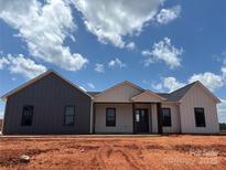Inviting new construction home featuring a stylish two-tone exterior and covered front porch at 1370 Coppergate Dr, Salisbury, NC 28147