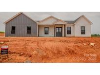 New construction home featuring a modern design with gray and white siding, and a covered front porch at 1370 Coppergate Dr, Salisbury, NC 28147