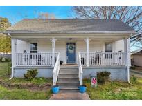 Charming home featuring a cozy front porch, welcoming entryway, and well-maintained landscaping at 210 W Lee Ave, Bessemer City, NC 28016