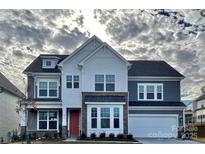 Charming two-story home featuring stone accents, a red front door, and a two-car garage at 278 W Waterlynn Rd, Mooresville, NC 28117