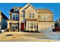 Beautiful two-story home with stone accents, gray siding, well-manicured lawn, and a two-car garage at 278 W Waterlynn Rd, Mooresville, NC 28117