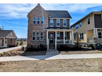 Charming two-story home featuring mixed brick and siding exterior with inviting front porch at 279 Luray Way # 448, Rock Hill, SC 29730