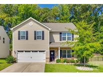 Charming two-story home featuring a two-car garage and well-maintained landscaping at 317 Praline Way, Fort Mill, SC 29715