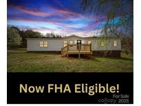 Charming single-story home features a cozy front porch and picturesque sunset views at 35494 Dry Rd, Albemarle, NC 28001