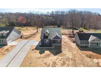 New construction home with a paved driveway, landscaped yard, and craftsman style details at 4005 Miller Rd, Salisbury, NC 28147