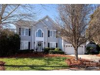 Charming two-story home with manicured lawn, mature trees, and welcoming front porch at 625 Circle Trace Rd, Monroe, NC 28110