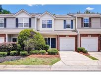 Townhouse exterior with brick accents, an attached garage, and landscaped front yard at 804 Eddy Dr, Fort Mill, SC 29715