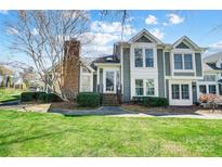 Charming townhouse with well-maintained landscaping and a brick chimney at 8250 Tradd Ct, Charlotte, NC 28210