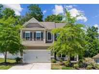 Charming two-story home with a well-maintained front yard and a two-car garage at 117 Cramerton Mills Pkwy, Cramerton, NC 28032