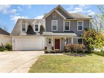 Charming two-story home with a well-manicured lawn and a welcoming red front door at 134 Cline St, Concord, NC 28027