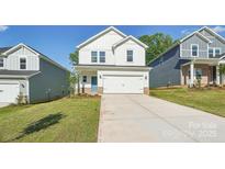 Charming two-story home boasts a well-maintained lawn, a two-car garage, and a welcoming blue front door at 138 Satchel Ct, Mooresville, NC 28115