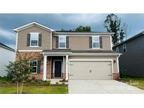 Charming two-story home features a two-car garage, brick accents, and manicured landscaping at 142 Shepherds Landing Dr, Mooresville, NC 28115