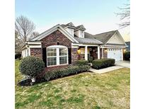 Charming single-story brick home with manicured landscaping, dormer windows, and a two-car garage at 269 Loch Stone St, Fort Mill, SC 29715