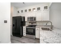 Updated kitchen with white cabinetry, stainless steel appliances, and granite countertops at 4028 Center Place Dr, Harrisburg, NC 28075