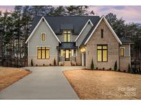 Beautiful two-story home featuring a brick and siding exterior with a long driveway and well-maintained landscaping at 4069 Rivendell Rd # 5, Denver, NC 28037