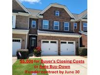 Charming brick townhome with a two-car garage and inviting curb appeal at 113 Burlingame Ct # C, Mooresville, NC 28117