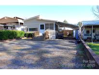 Charming single-story home featuring a gravel yard and covered parking at 137 Holly Harbor Trl, Mount Gilead, NC 27306