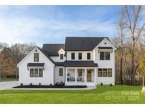 Charming two-story modern farmhouse with black frame windows and a cozy front porch at 1465 Highcrest Way, Rock Hill, SC 29730