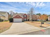 Charming two-story home with brick accents, white garage door, and a well-manicured front yard at 147 Amber Woods Dr, Tega Cay, SC 29708