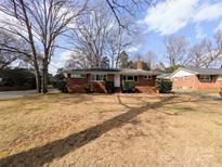 Charming single-story brick home featuring a well-maintained front yard under a sunny sky at 4801 Kipling Dr, Charlotte, NC 28212