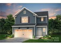 Charming two-story home featuring a welcoming two car garage and beautifully designed exterior at 13014 Garren View Ln # 306, Charlotte, NC 28278