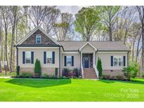 Charming single-story home with stone accents, manicured lawn, and inviting entryway at 1823 Rain Forest Dr, York, SC 29745